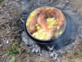 Top of the Vrshnik removed showing cooked wild rabbit and potatoes