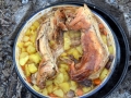 Top of the Vrshnik removed showing cooked wild rabbit and potatoes