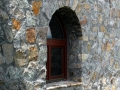 A window in the stone face of the Priest's Tower